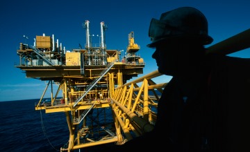 Silhouette of a rig worker on an offshore platform